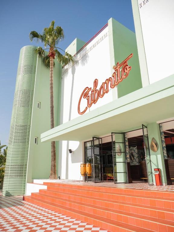 a building with a cocacola sign on it at Cubanito Ibiza in San Antonio