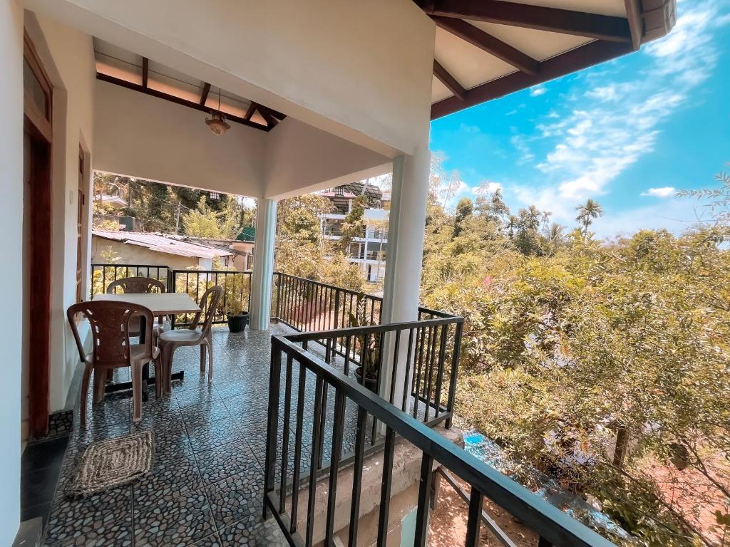 a balcony of a house with a table and chairs at The Grand Residence in Ella