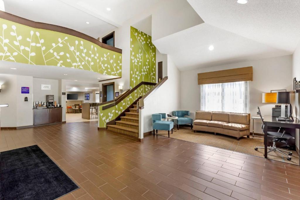 a lobby with a staircase and a living room at Sleep Inn at Greenville Convention Center in Greenville