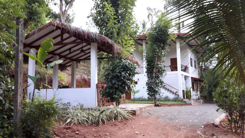 a house in the middle of a forest at Zee's Garden in Matale