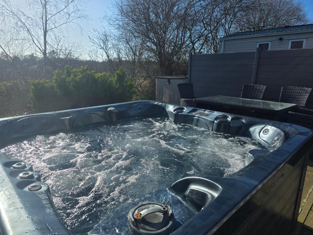 a jacuzzi tub with water in it at Dixons Den Hot Tub in Swarland