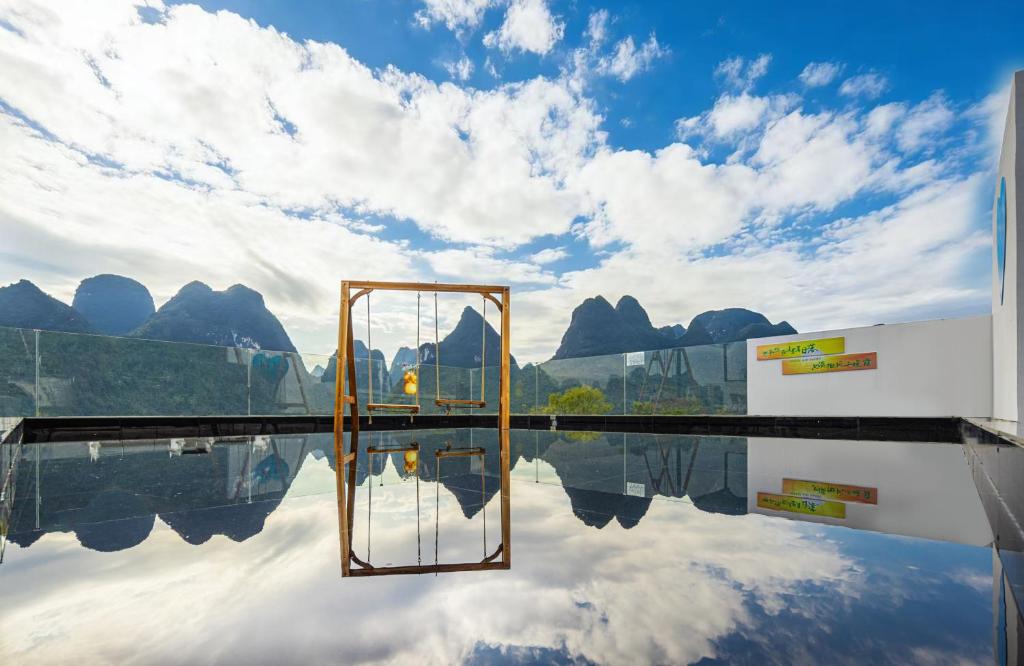 a reflection of the sky in a pool of water at Jiheshan residential accommodation Yulong River Yangshuo in Yangshuo