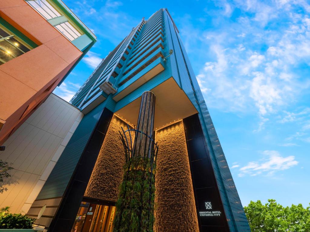 a tall building with a tree in front of it at ORIENTAL HOTEL UNIVERSAL CITY in Osaka