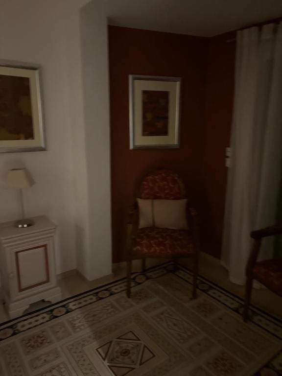 a living room with a chair and a table at Confort Taillans in Donzère