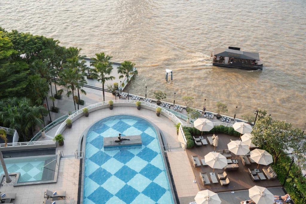 An elevated view of a rooftop pool and its riverside deck.