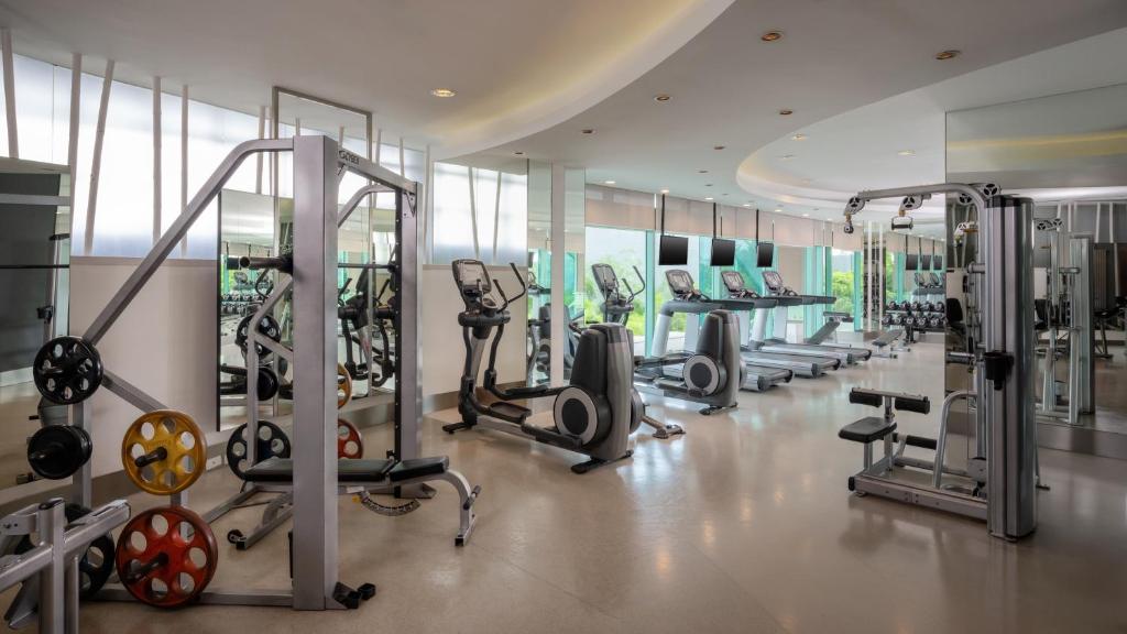 A bright, spacious fitness room with cardio and weight-training equipment.