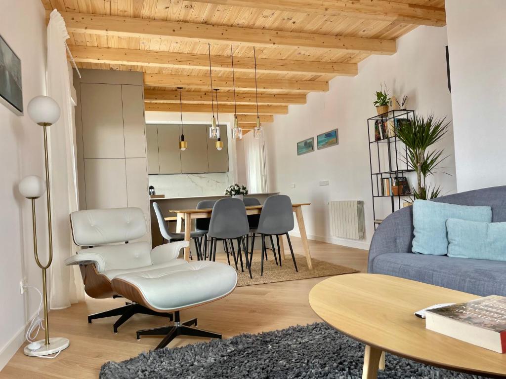 a living room with a blue couch and a table at Señorial Panorámico by apartamentoscatedralcamino in Burgos