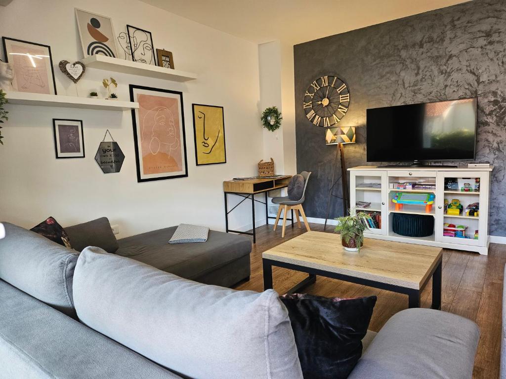 a living room with a couch and a tv at Apartment Rita in Mokošica