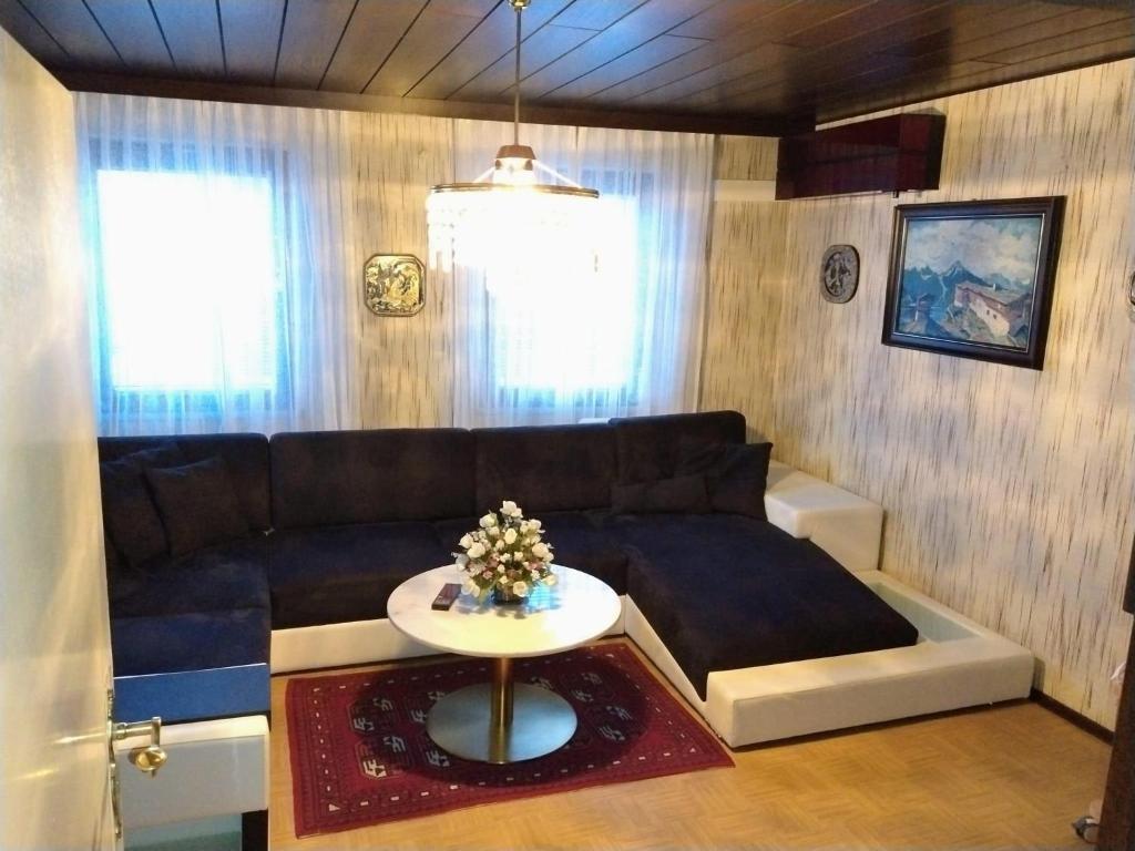 a living room with a couch and a table at Ferienhaus Waldkrone in Arrach