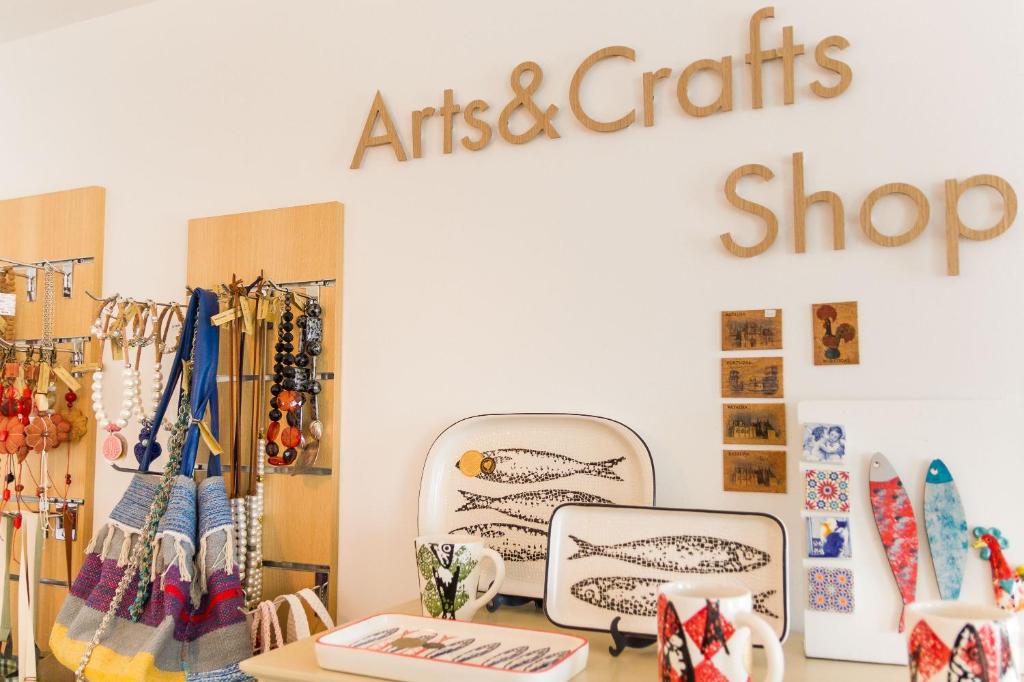 a clothing store with a store sign that reads artists and crafts shop at Boutique Hotel Casa do Outeiro - Arts & Crafts in Batalha