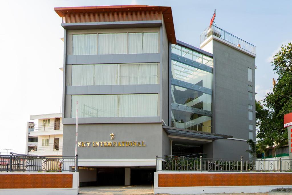 a building with a sign on the side of it at Hotel Sky International in Kizhake Chālakudi