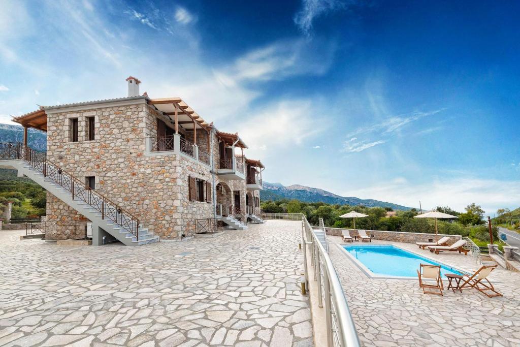 an exterior view of a house with a swimming pool at Elevi Aria in Tyros
