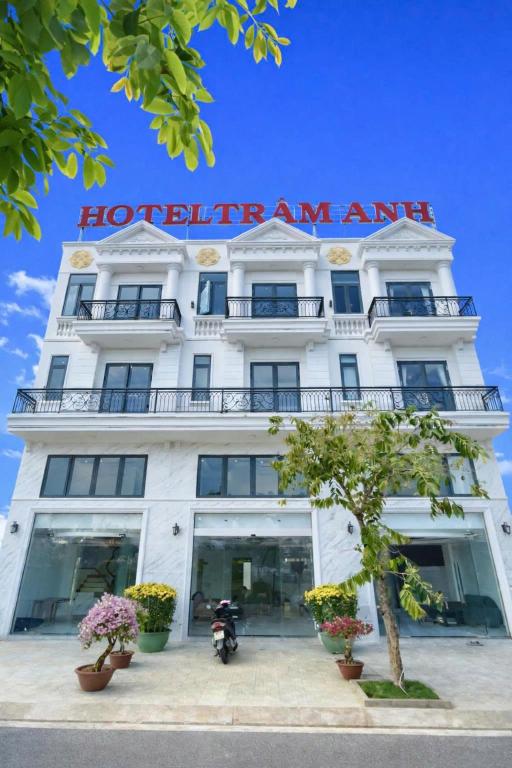 a white hotel with a sign on the front of it at Hotel Trâm Anh 3 in Nhơn Trạch