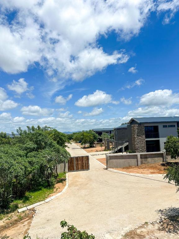 an empty driveway leading to a building at The Solis Aparthotel in Mzinti