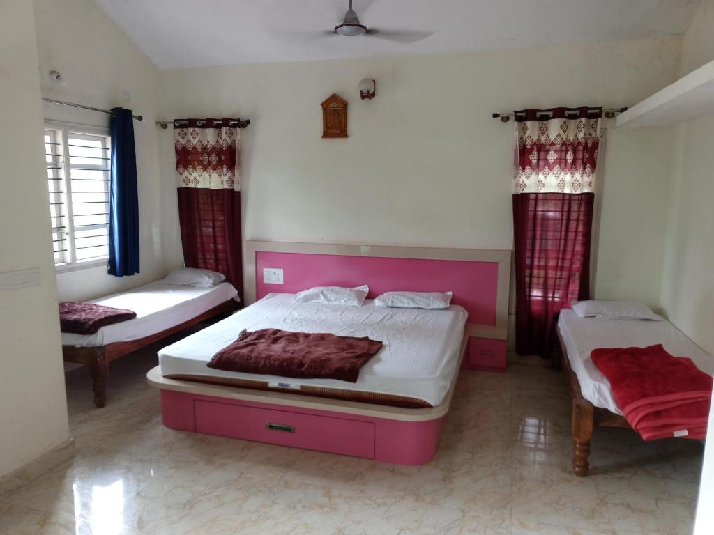a bedroom with two beds and two windows at HALASE HOMESTAY mudigere in Mudigere