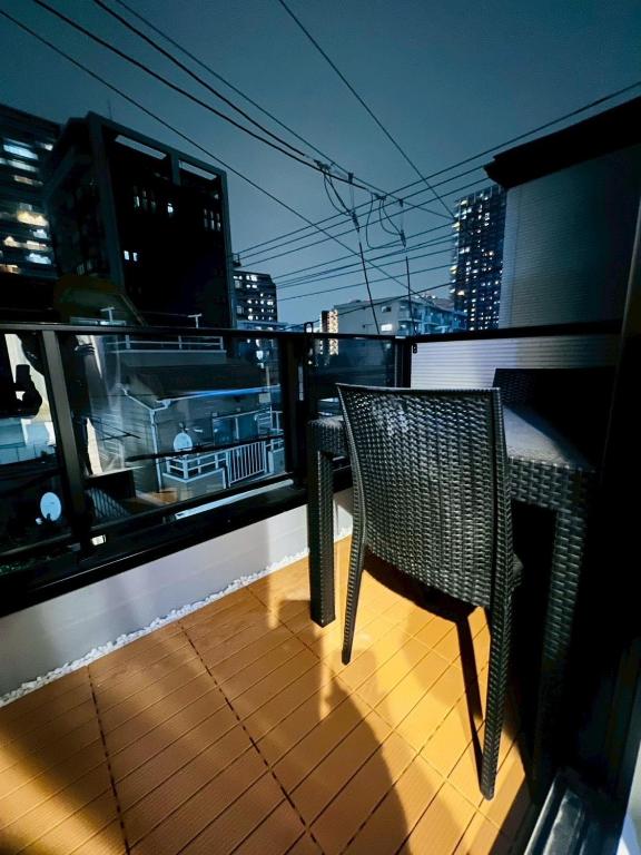 a balcony with a table and chairs on a city skyline at Sky Terrace Kawaguchi in Kawaguchi
