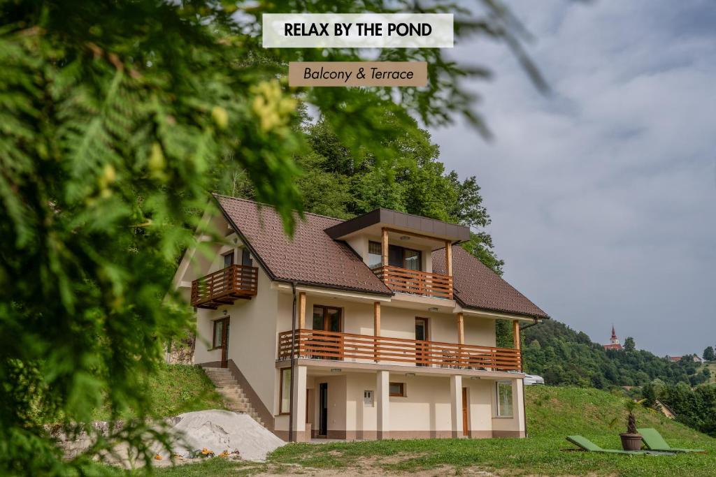 a house on a hill with the words walk by the pond blayney at Ribnik Stari trg in Lesično