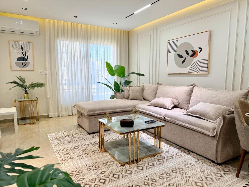 a living room with a couch and a table at LUXURY apartment October City in 6th Of October