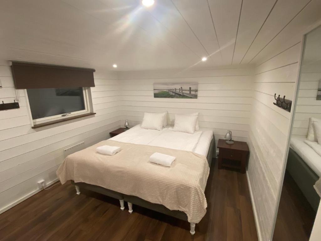 a bedroom with a bed with two towels on it at Port Hotel Ocean Villa in Karlshamn