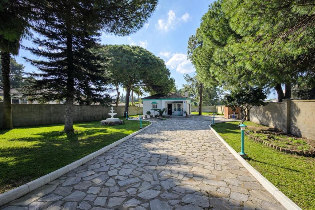 a cobblestone path in a yard with a house at Chalet Amanecer Chiclana in Novo Sancti Petri