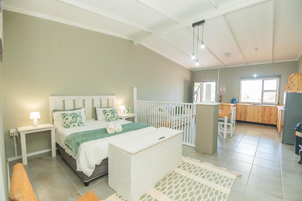 a bedroom with a bed and a dining room at Accommodation on 3329 - Unit 2 in Gqeberha