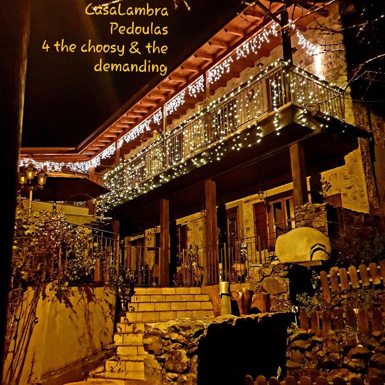 a building with christmas lights on the side of it at CasaLambra Pedoulas Exclusive Accomodation Troodos Mountains in Pedoulas