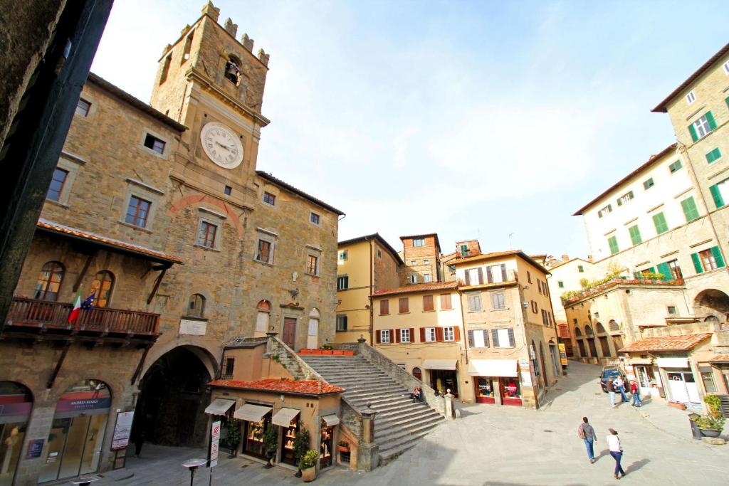 a building with a clock tower in a city at La Casa sulla Piazza in Cortona