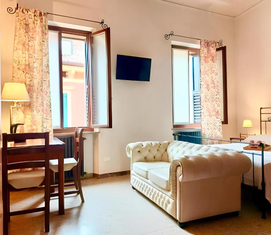 a living room with a couch and a table and windows at Elle Palace - Simply Elegant in Verona
