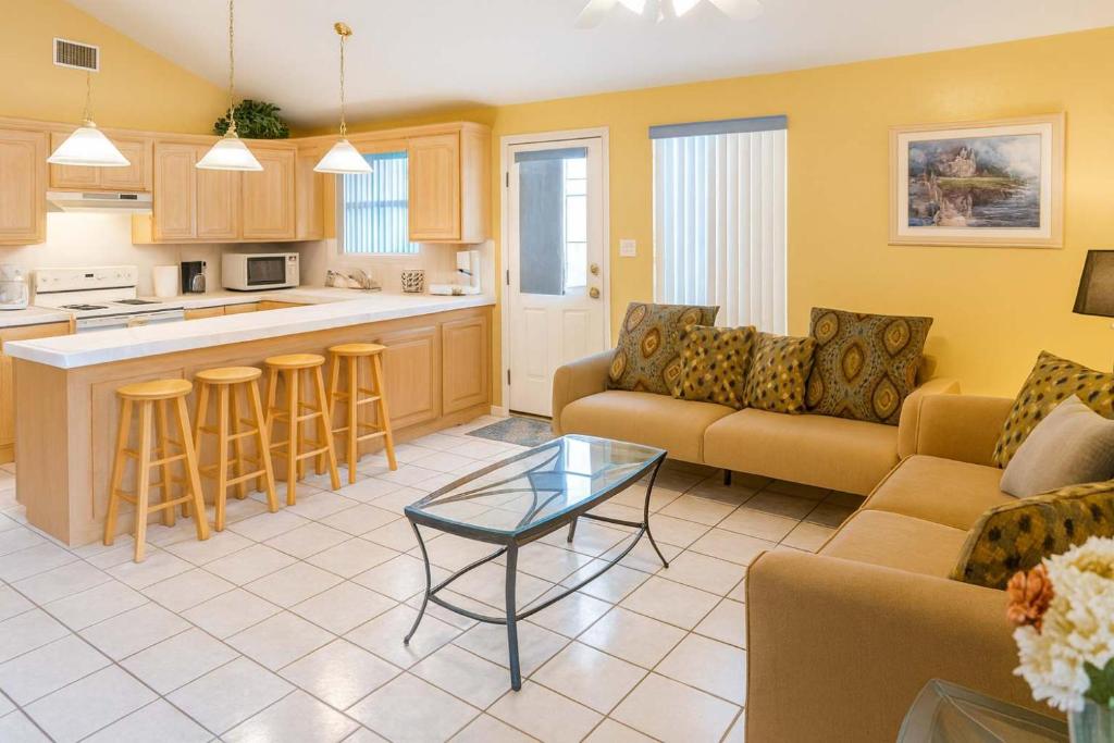 a living room with a couch and a table at BBQ ok Ground Floor Duplex 1-2 block to Beach in South Padre Island