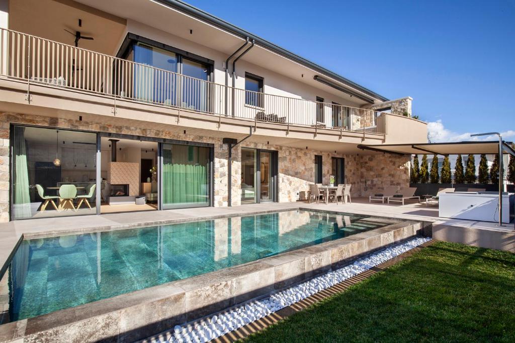 a swimming pool in the backyard of a house at Villa Olivida in Garda