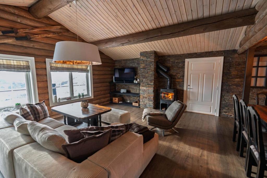 a living room with a couch and a table at Meraftahornvegen 36 in Stranda