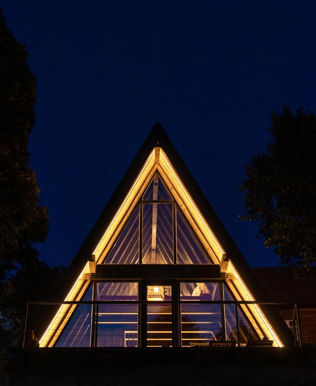 a glass house lit up at night at Hai La Munte Bran in Bran