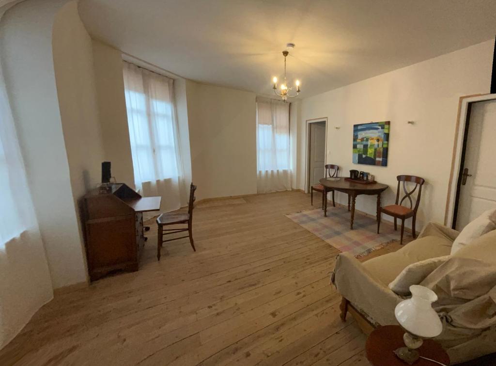 a living room with a couch and a table at Le Dorat Bright & Quiet in Le Dorat