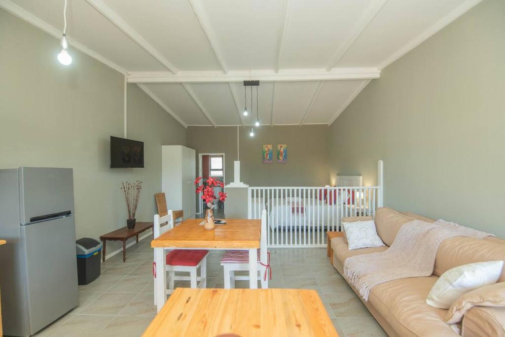 a living room with a couch and a table at Accommodation on 3329 - Unit 3 in Gqeberha