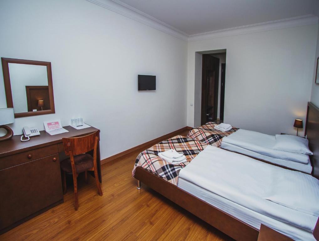 Postel nebo postele na pokoji v ubytování Hotel Lux