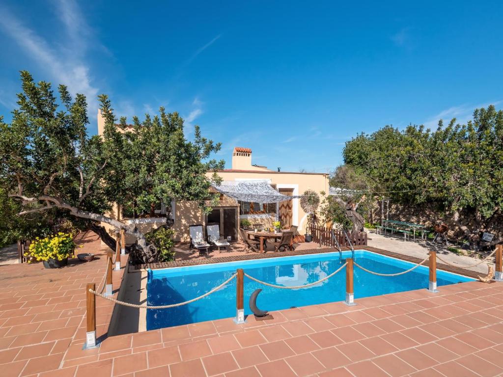 a swimming pool in front of a house at Flor de Besso in Llucmajor