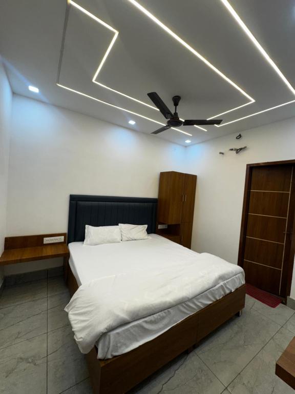 a bedroom with a bed with a ceiling fan at Hotel HB Grand in Anūpgarh
