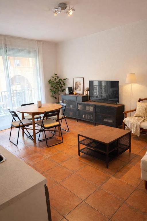 a living room with a table and a couch at Loft cosy au portes d'avignon in Les Angles Gard