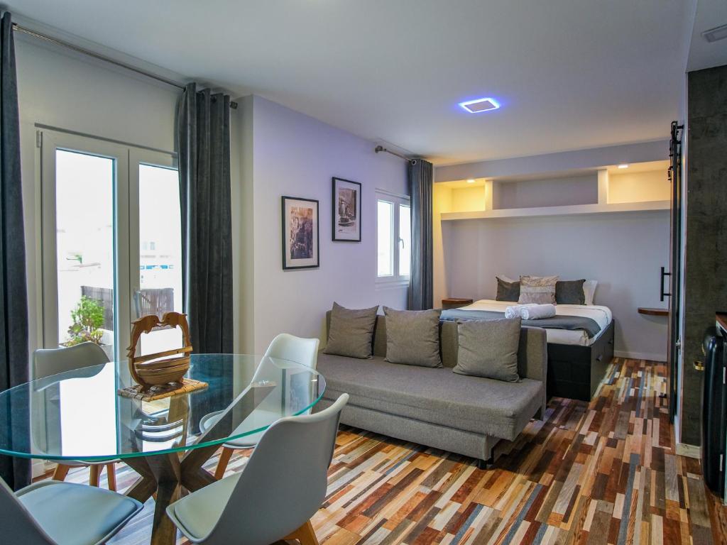 a living room with a couch and a glass table at Oceanway Apartment in the Center of Baleal in Ferrel