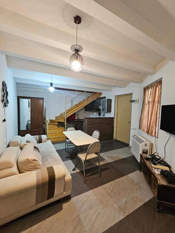 a living room with a large bed and a table at Home in Ancient District in Tbilisi City