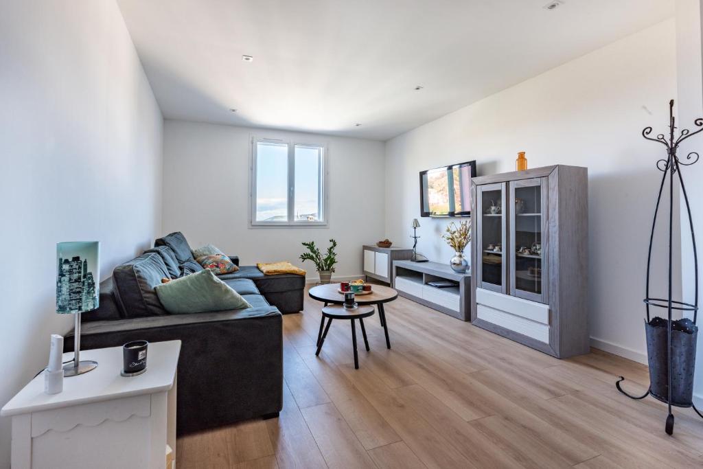 a living room with a couch and a table at Nebbiu - 25km de Bastia in Murato