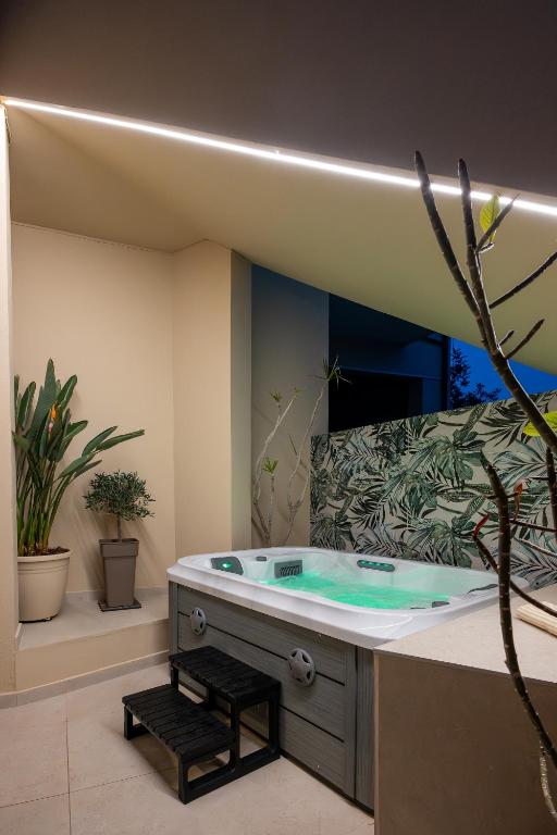 a bathroom with a jacuzzi tub with a mirror at Olea Blue Suite in Stalís