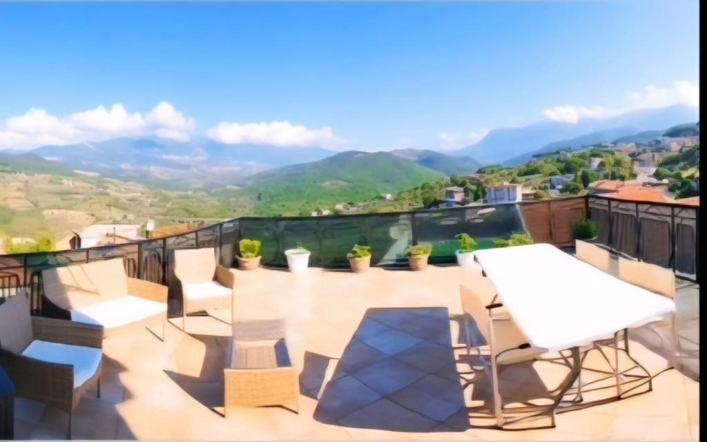 a balcony with chairs and a table and a view at La terrazza in Contursi