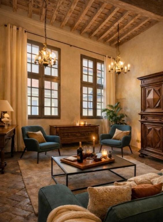 a living room with a couch and chairs and a table at L'écrin de la Chartreuse in Villeneuve-lès-Avignon