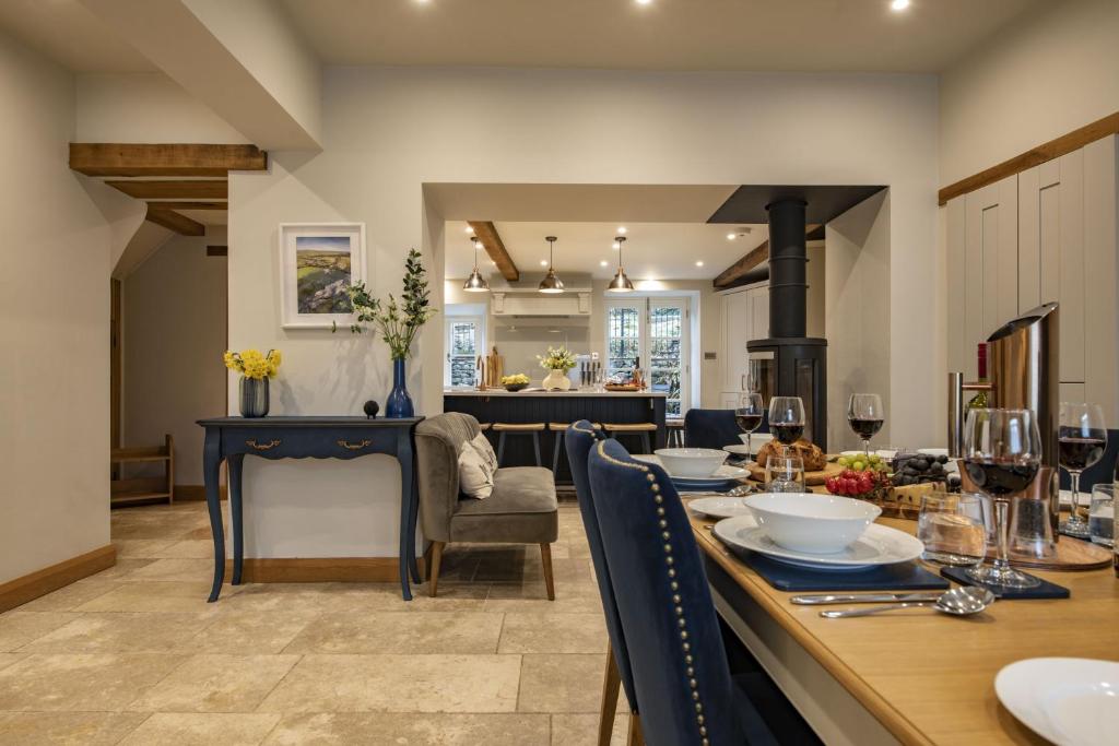 a dining room and kitchen with a table and chairs at Beckside in Kettlewell