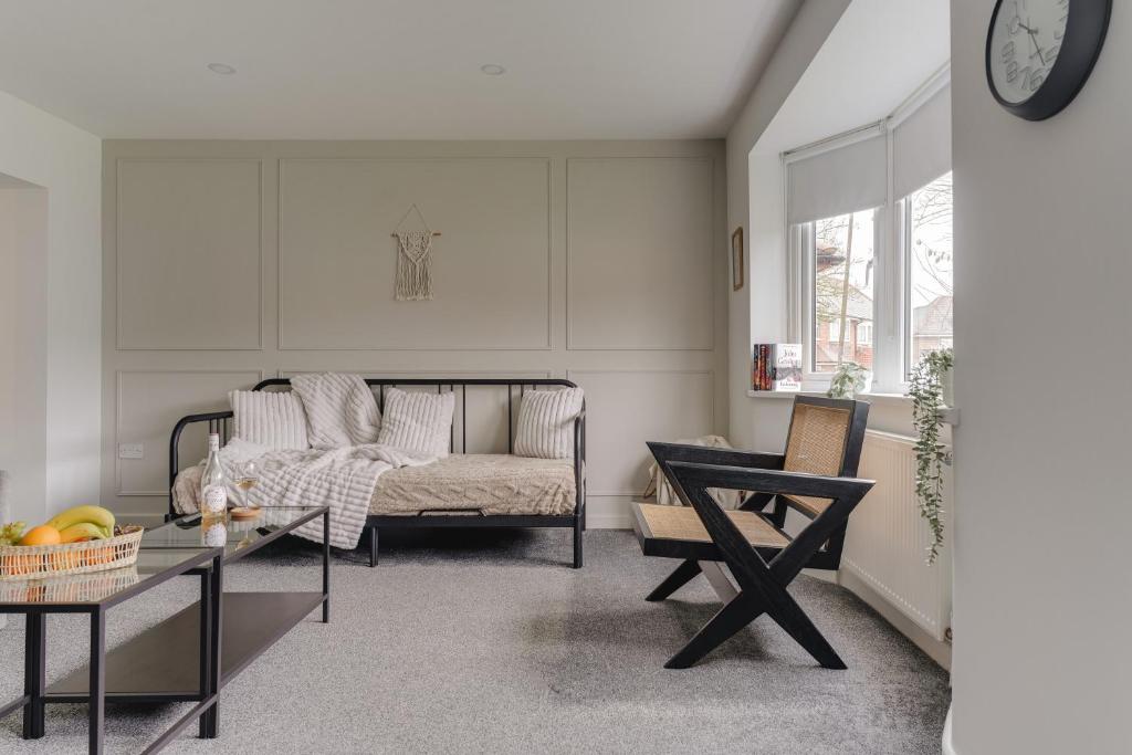 a living room with a couch and a table at Contractor friendly 3BDR Home | Parking for Vans in Salford