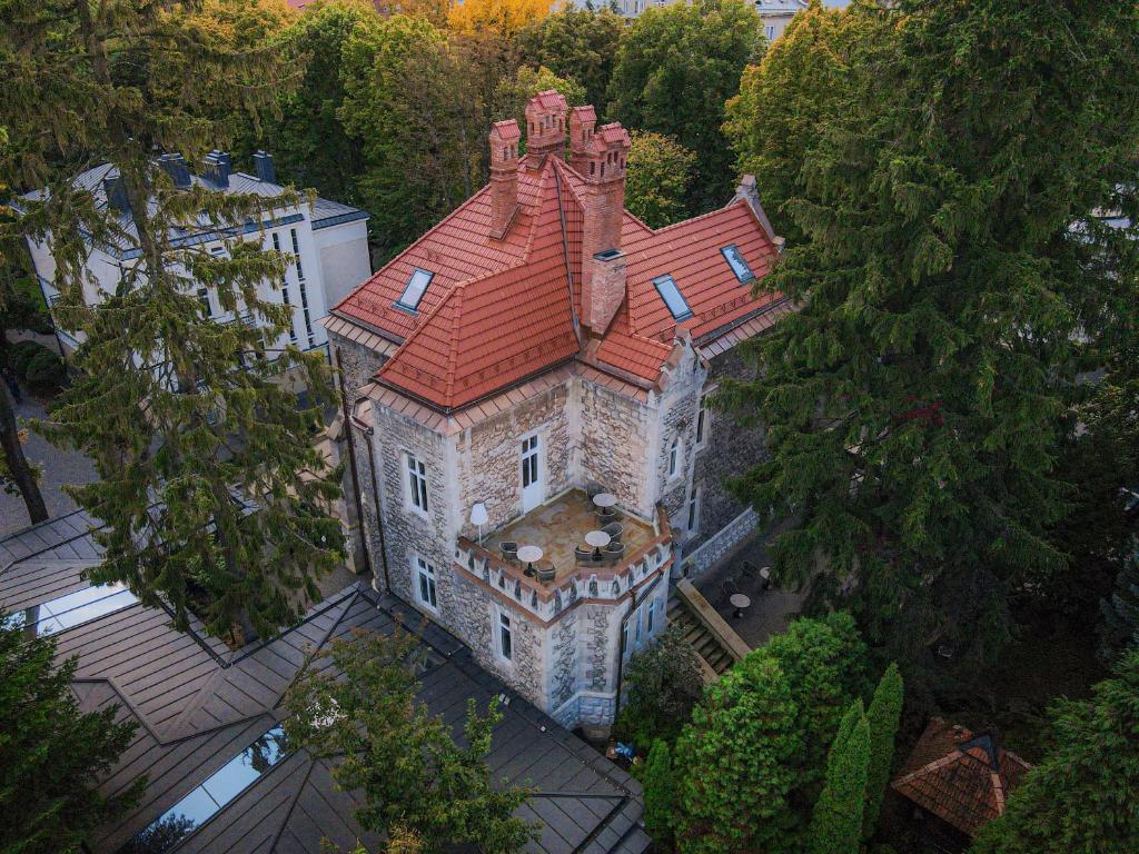 an aerial view of an old house with a red roof at Lion's Castle Hotel in Lviv