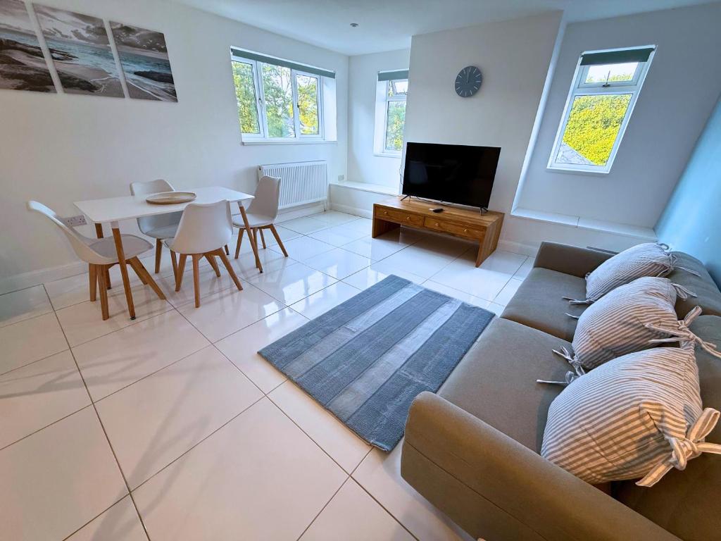 a living room with a couch and a table at New 3 Bedroom Flat Close to Station in Chepstow