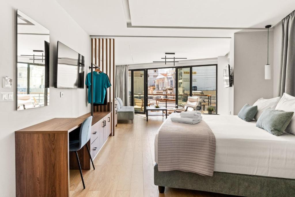 a bedroom with a bed and a desk with a computer at Bedspot Heraklion in Heraklio