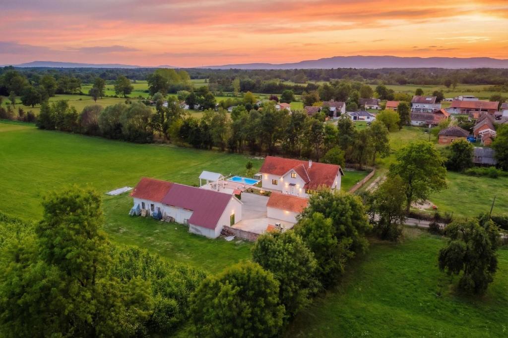 an aerial view of a house on a green field at Green Oasis Estate with Private Pool and Backyard near Zagreb in Velika Gorica